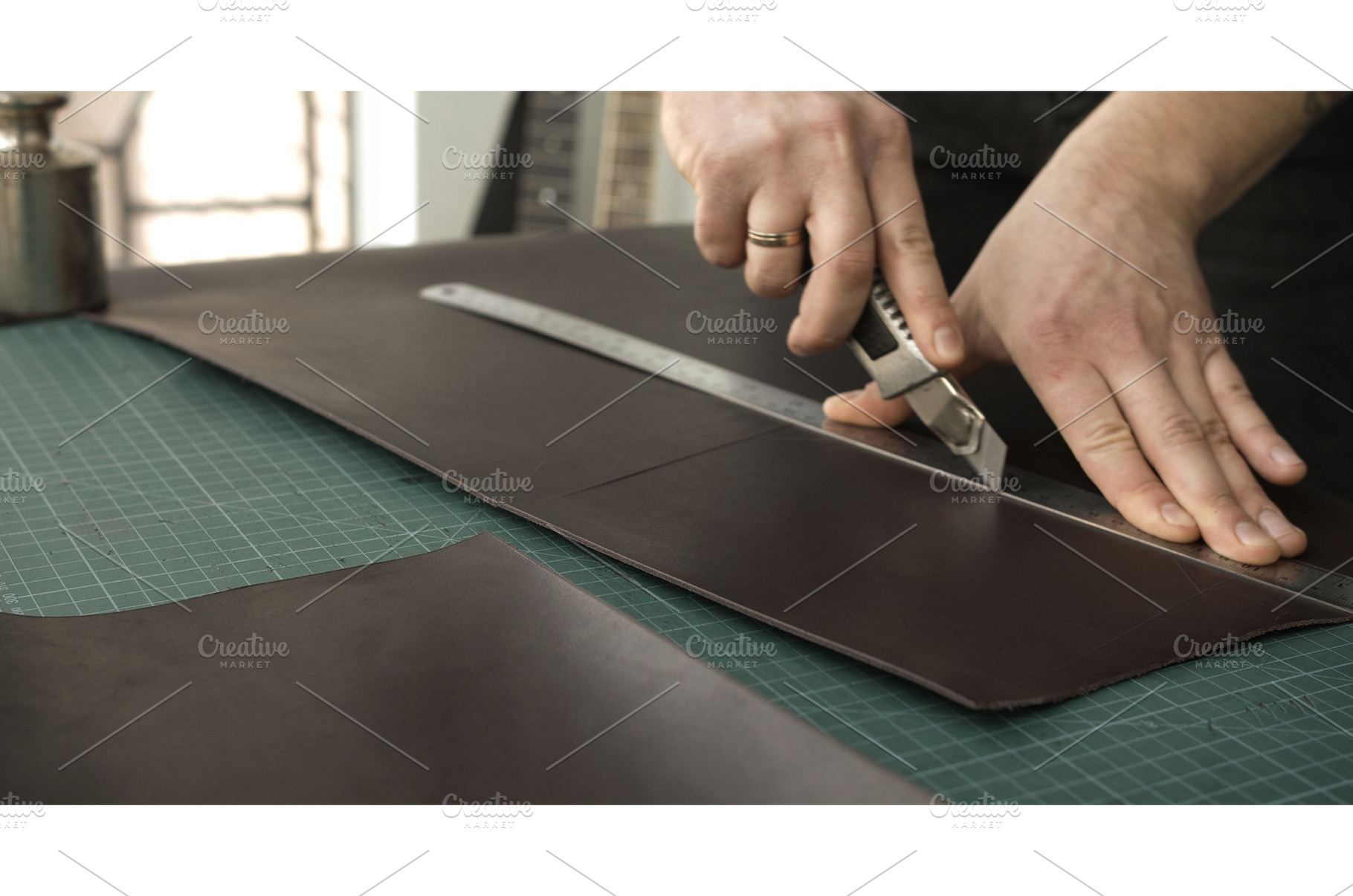 Cutting leather sheet with utility, a Person Photo by volodymyrshtun13795