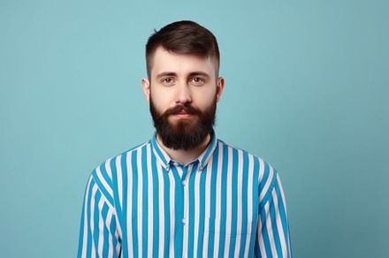 Young bearded man with striped shirt, a Person Photo by RamsaGraphi