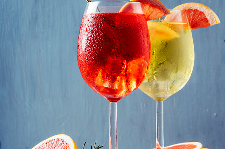 Red and white aperol spritz garnish in wine glasses with rosemar, a Food & Drink Photo by hitdelight