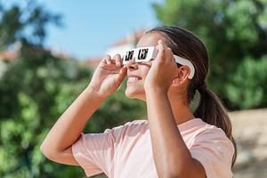 Young girl watches a solar eclipse