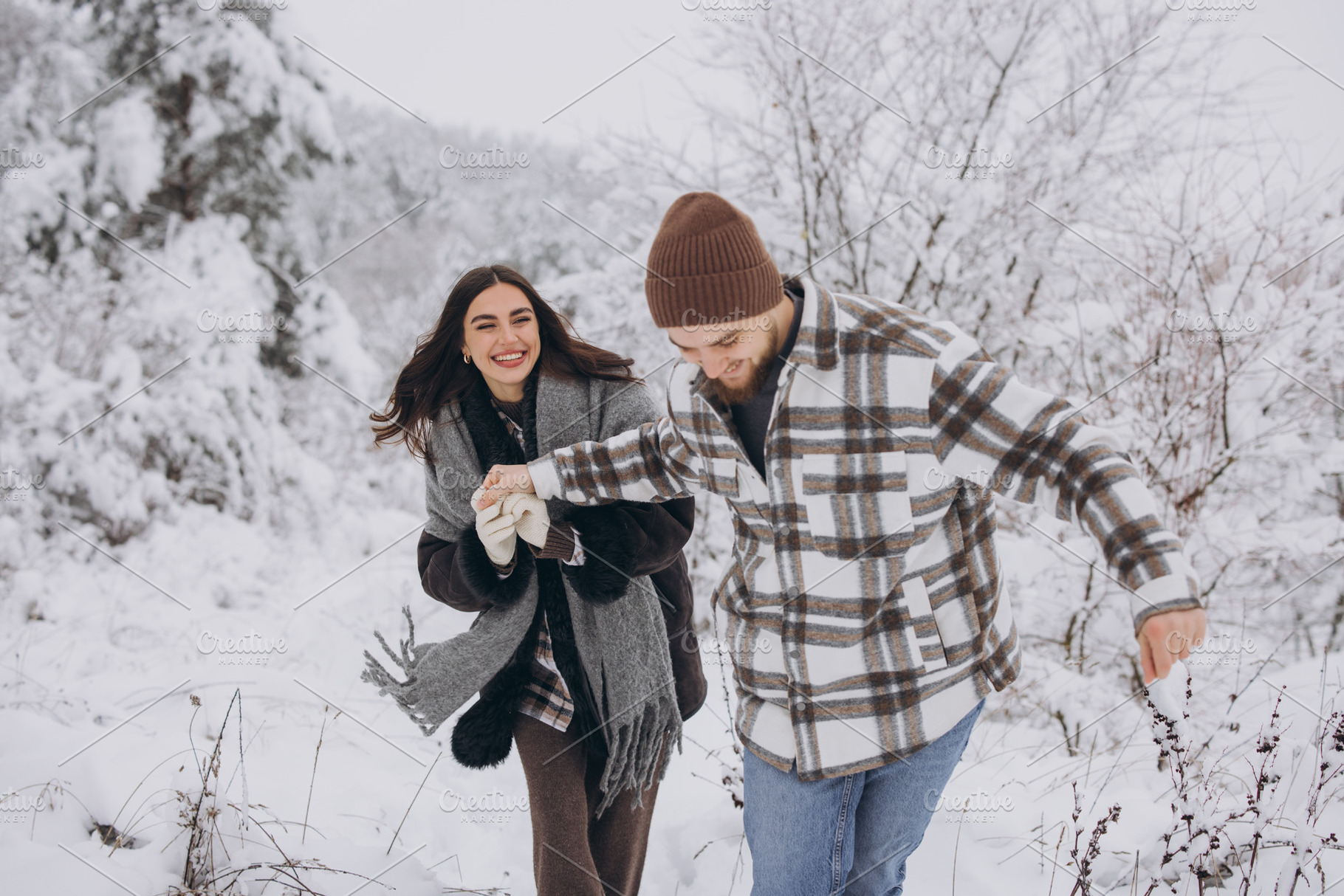 A young happy and loving couple walking in a snowy forest in the, a Person Photo by Cherkas Photography