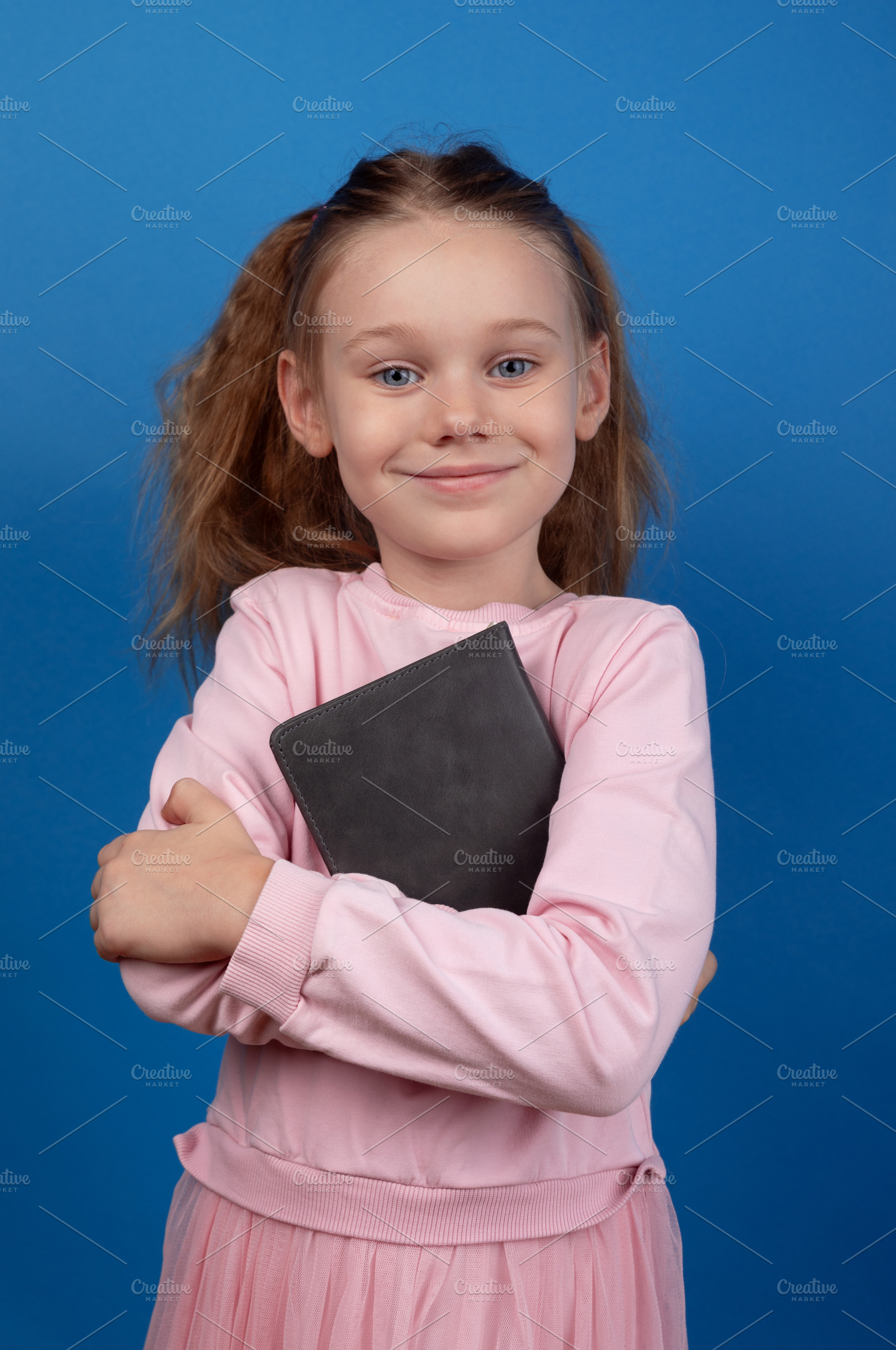 Smiling Girl Holding Book, a Person Photo by Ales Munt
