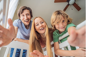 Parents and older brother looking