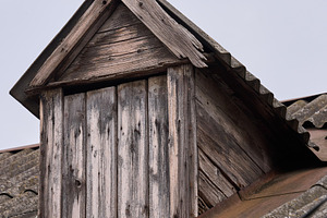 Weathered wooden dormer window on an old tiled roof. The aged wo, an Architecture Photo by ndanko