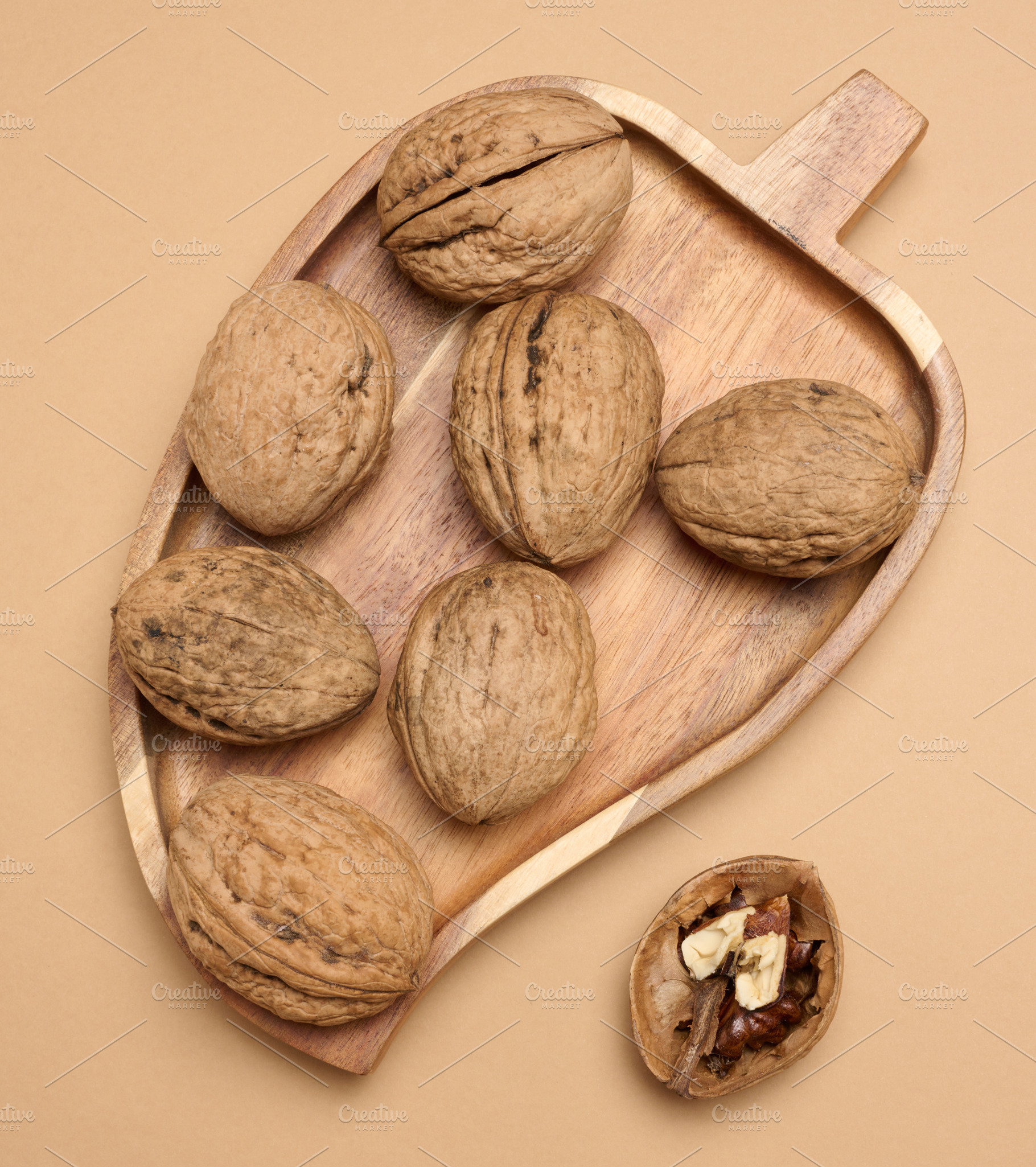 Walnut fruits on a brown background, close up, a Food & Drink Photo by ndanko