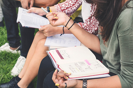 Students doing homework in the park containing african, african descent, and, a Person Photo by rawpixel