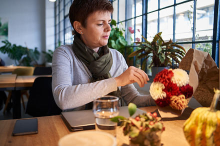 Woman sitting in a cafe with a notebook, a Food & Drink Photo by Madeleine Steinbach