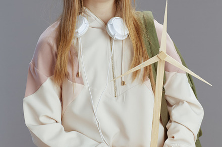 happy modern teen girl in beige tracksuit with headphones, a School & Education Photo by Alliance Images