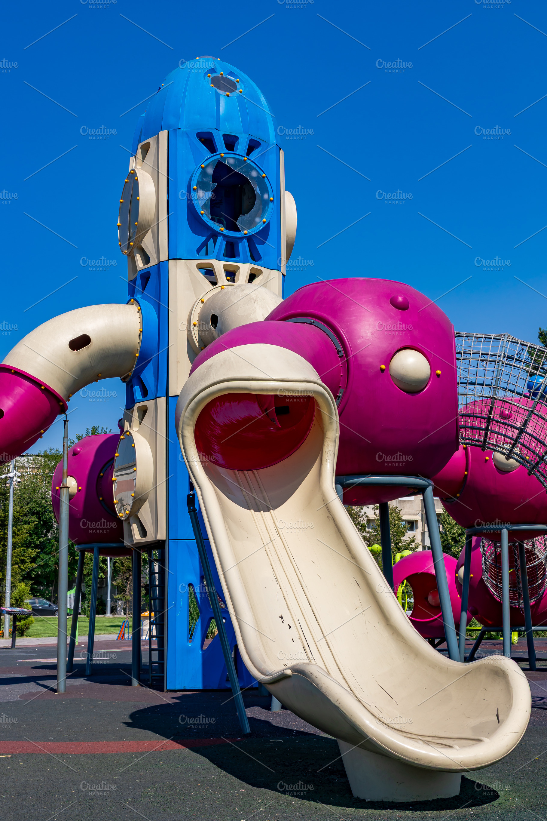 Brightly colored playground with space rocket design, featuring a large slide a, a Sports & Recreation Photo by Ales Munt