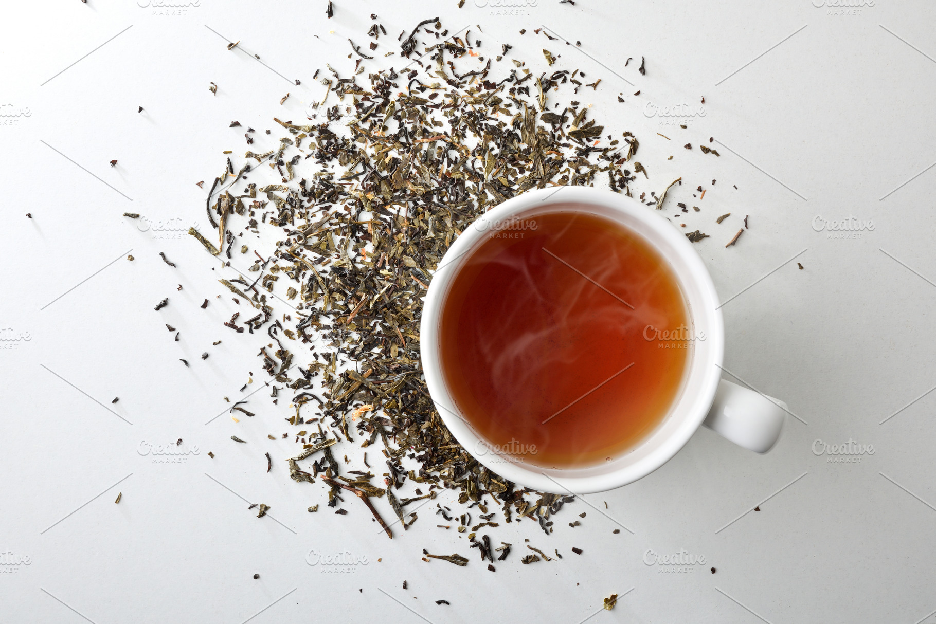 Hot infusion on white table with dried medicinal herbs, a Food & Drink Photo by Davizro's Market