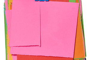 Stack of colorful square sticky notes with jagged edges, secured, a Business Photo by ndanko