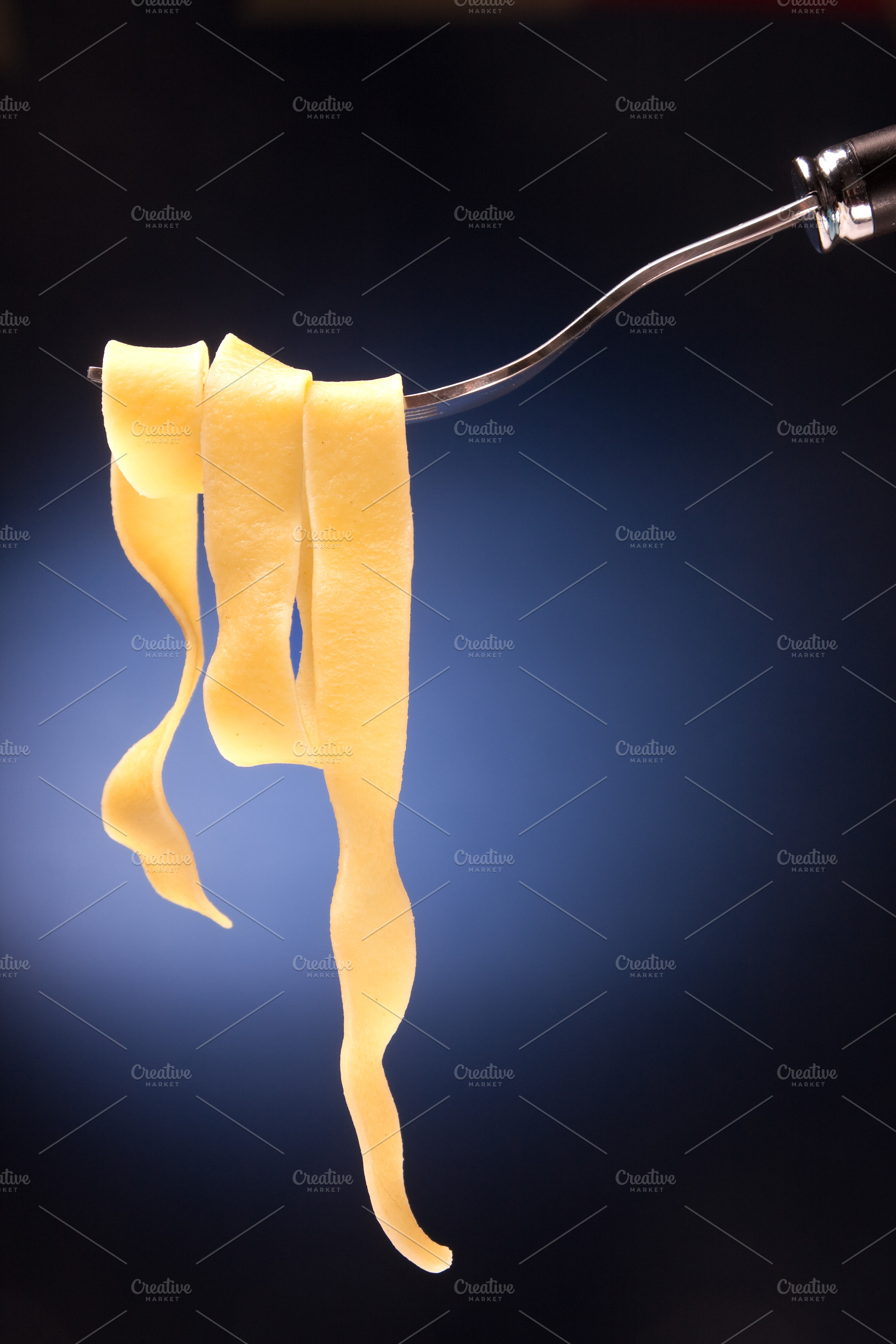 Fork with tagliatelle on a red background, a Food & Drink Photo by FoodStock
