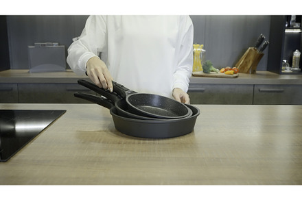 New set of frying pans demonstrated, a Food & Drink Photo by Media Whale Stock