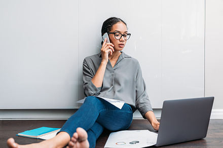 Young female using a laptop and talk, a Business Photo by Artem Varnitsin