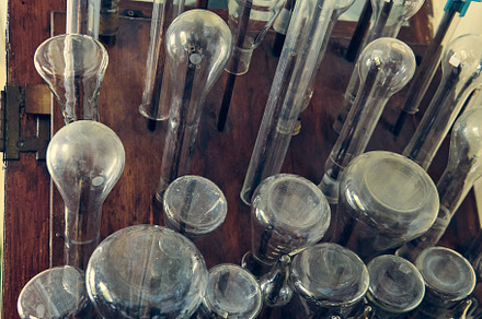 Glass bottles, test tubes, flasks and cups in an old chemical laboratory, a Technology Photo by Rohan Photography