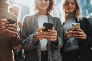 Young adults using smartphones city, a Photo by Pixeness Studio