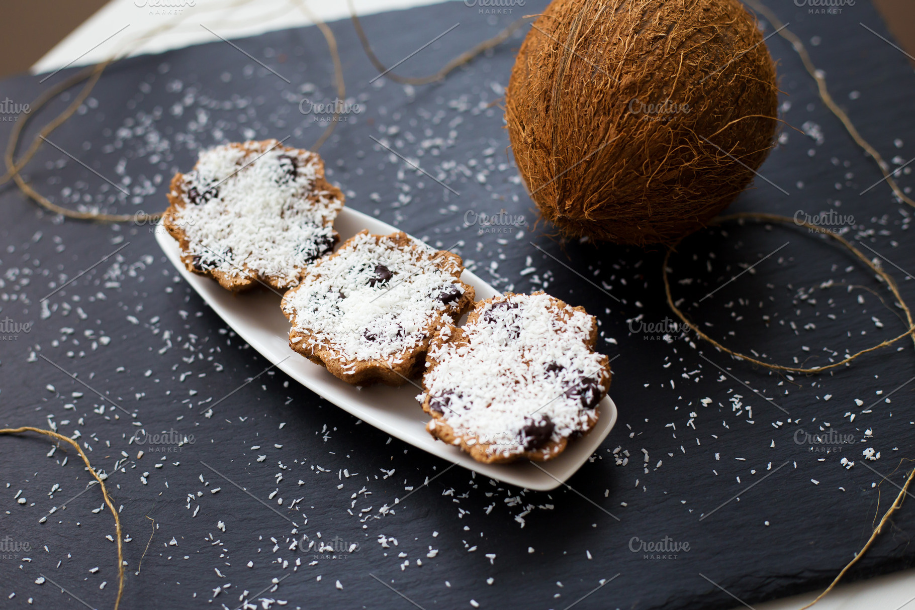 coconut muffins on a black background, a Food & Drink Photo by Artsaba Family