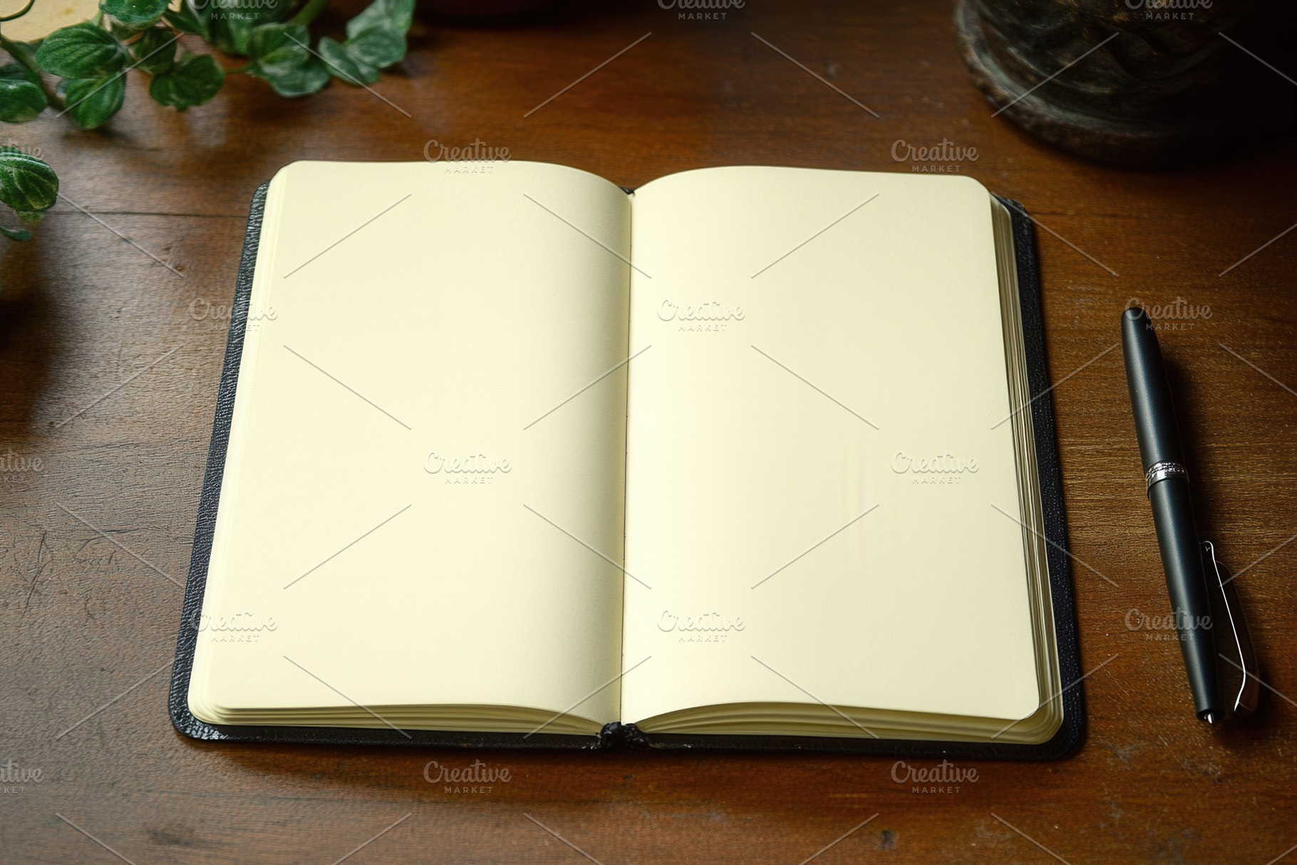 Open notebook on wooden table, a Photo by Pavel_design