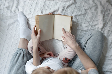 Mother reading book to her daughter stock photo containing love and lifestyle