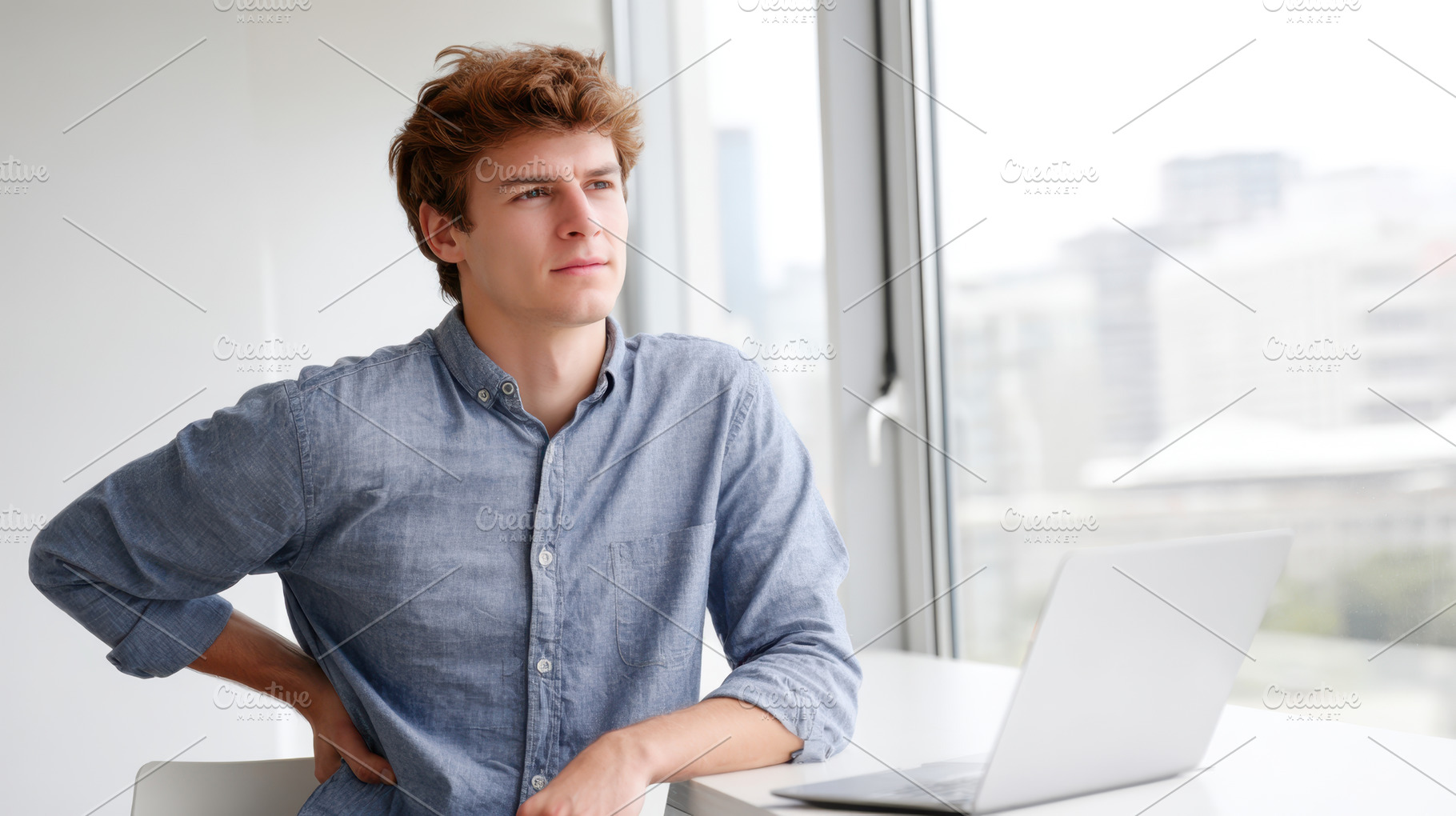 Man with back pain working on laptop at home office, a Person Photo by AlyaAnd