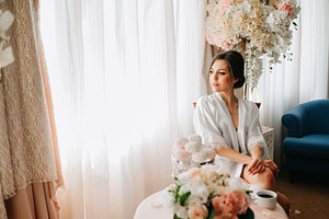 A young bride sits at a slot machine in the morning and drinks c