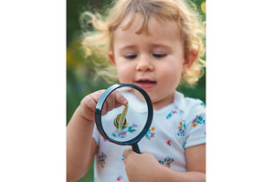 A child is studying a snail in the, a Nature Photo by yanadjana
