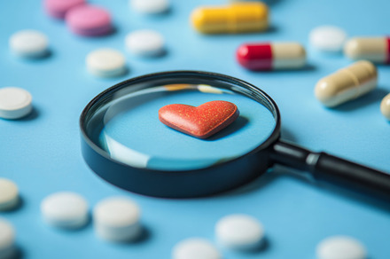 Magnifying Glass Over Heart Symbol Surrounded by Various Pills, an Abstract Photo by Natalia Klenova's Shop
