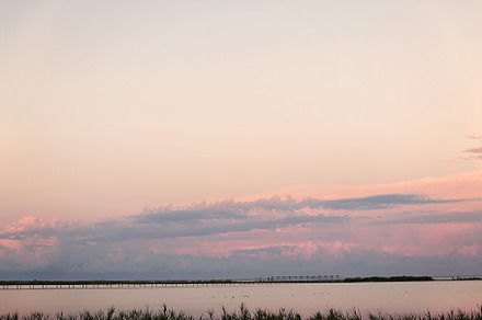 Landscape long bridge over a sea plait on a beautiful pink sunse, a Nature Photo by TanaCh