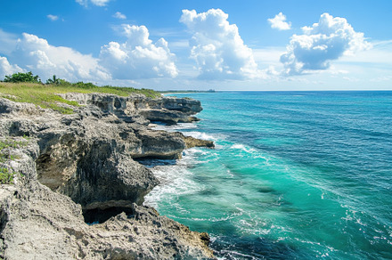 Coastal cliffs with turquoise waters, a Photo by Iftikhar Alam