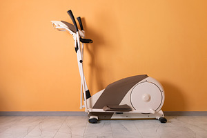 Elliptical Trainer on Orange Wall, a Sports & Recreation Photo by Ales Munt