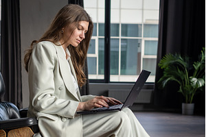 Laptop on knees of businesswomen, a Person Photo by undrey