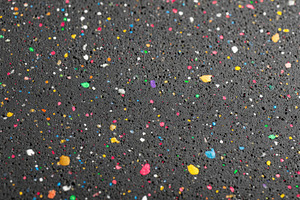 Colorful speckled particles on dark surface, a Background Photo by AlyaAnd