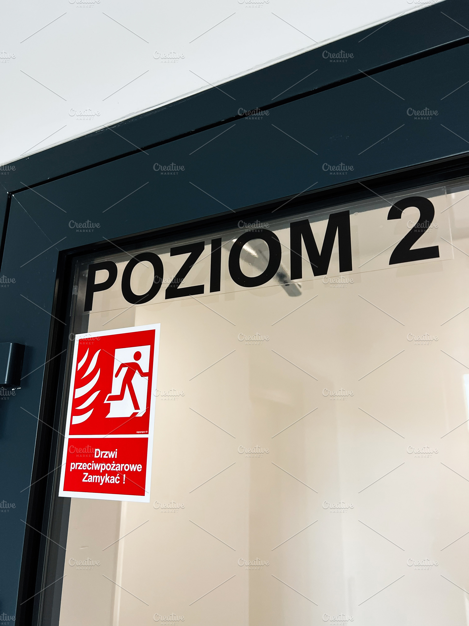 Door with Level 2 sign and red fire exit sticker for safety and emergency use, a Photo by AS photostudio