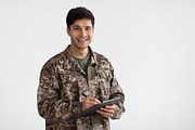 Smiling man in camouflage uniform holding folder, a Photo by Prostock-Studio (Thumbnail 3 of 3)
