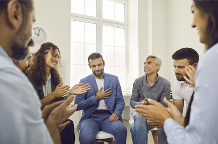 Group of diverse people sit in a, a Person Photo by StudioRomantic