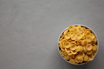 Dry, Uncooked Orecchiette Pasta in a Bowl, top view. Flat lay, o, a Food & Drink Photo by LiudmylaChuhunova