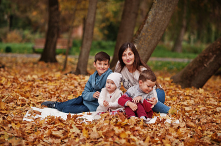 Happy family at autumn leaves park. Mother with three kids., a Person Photo by AS photostudio