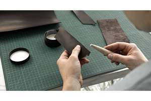 Preparing leather for edge finishing, a Person Photo by volodymyrshtun13795