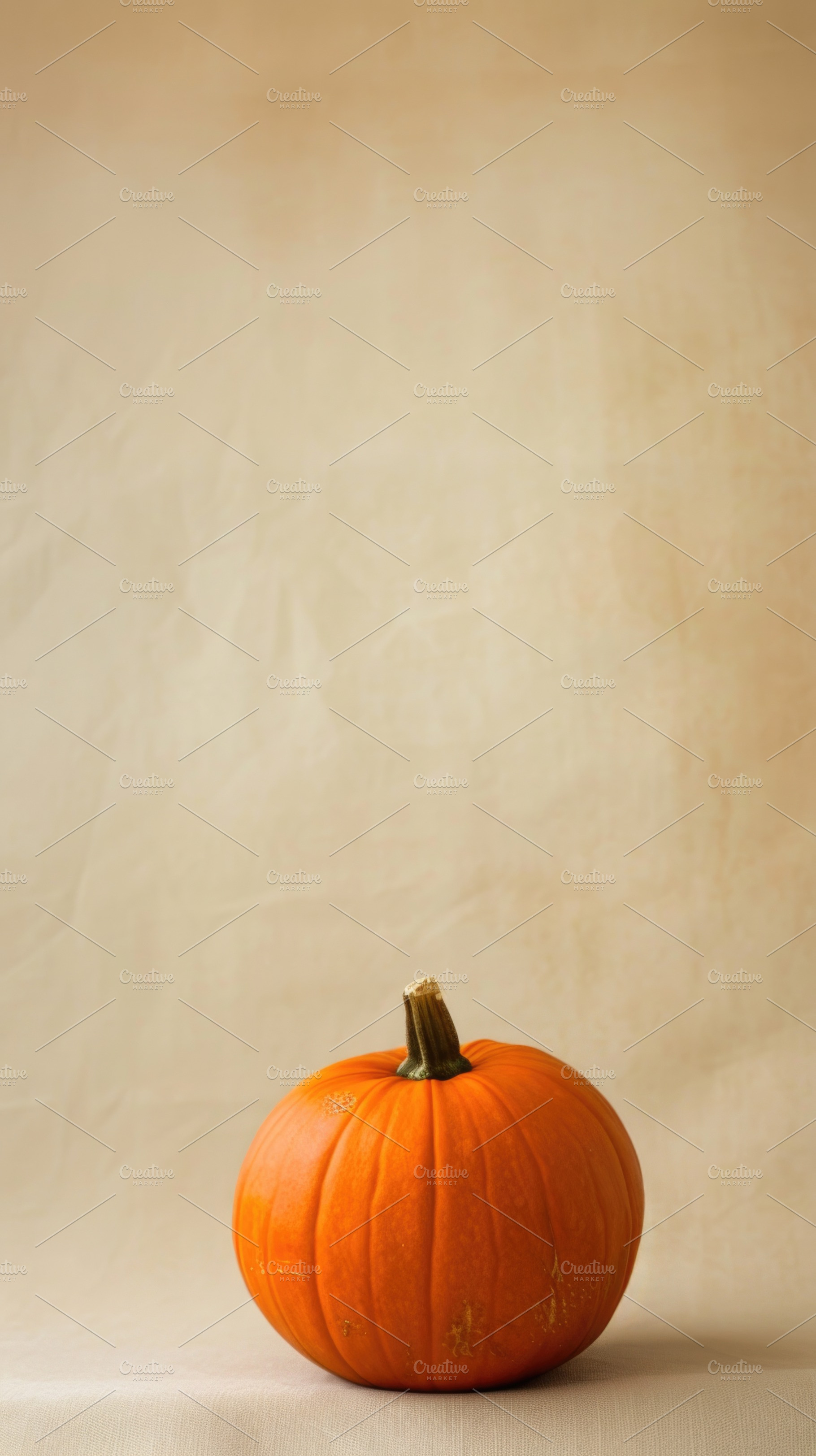 Minimal orange pumpkin on warm beige Halloween background, a Food & Drink Photo by José Manuel Gelpi