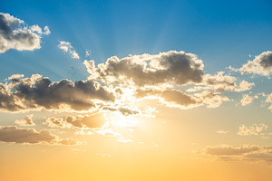 Sunset sky with clouds and sun