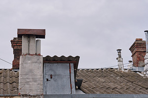 A close-up shot of several weathered chimneys on a rooftop, vary, an Architecture Photo by ndanko