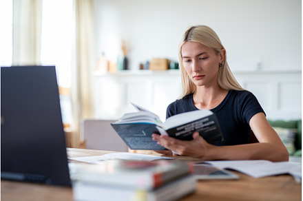 Woman student reading book sitting, a School & Education Photo by undrey
