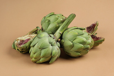 Concept of healthy food with artichoke on light brown background, a Food & Drink Photo by AtlasStudio