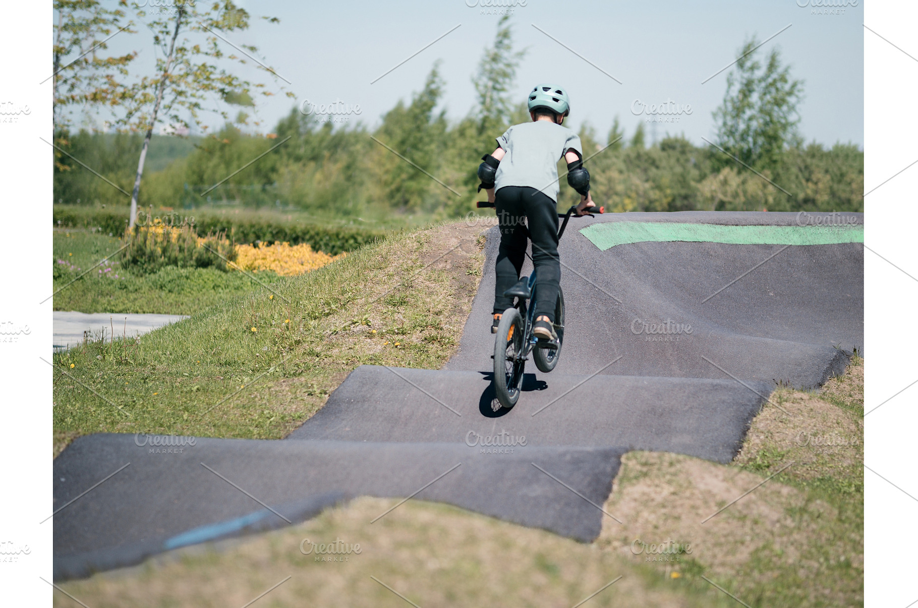 Pump track. Child on bmx bike rides, a Sports & Recreation Photo by Fascinadora
