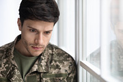 depressed military guy standing next to window, closeup, a Photo by Prostock-Studio (Thumbnail 1 of 3)