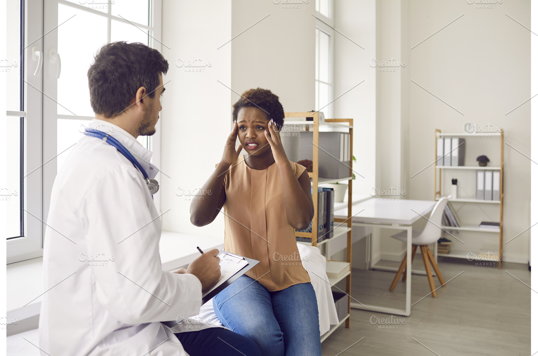 Male doctor consult black woman with, a Health & Medical Photo by StudioRomantic