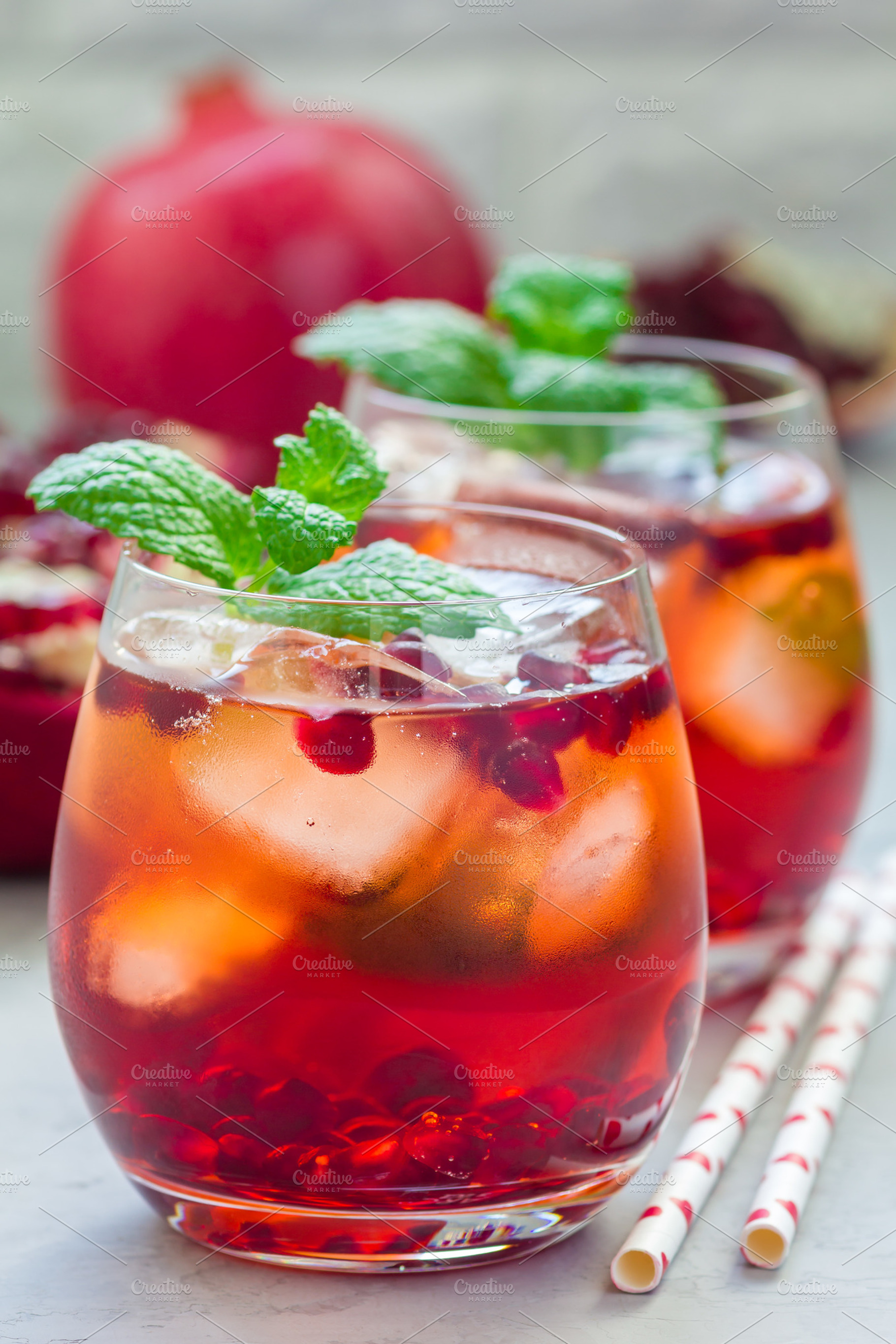 Mojito cocktail with pomegranate mint lemon juice and ice in glass vertical, a Food & Drink Photo by iuliia_n