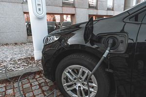 Electric car at EV charging station, a Transportation Photo by SkyNext