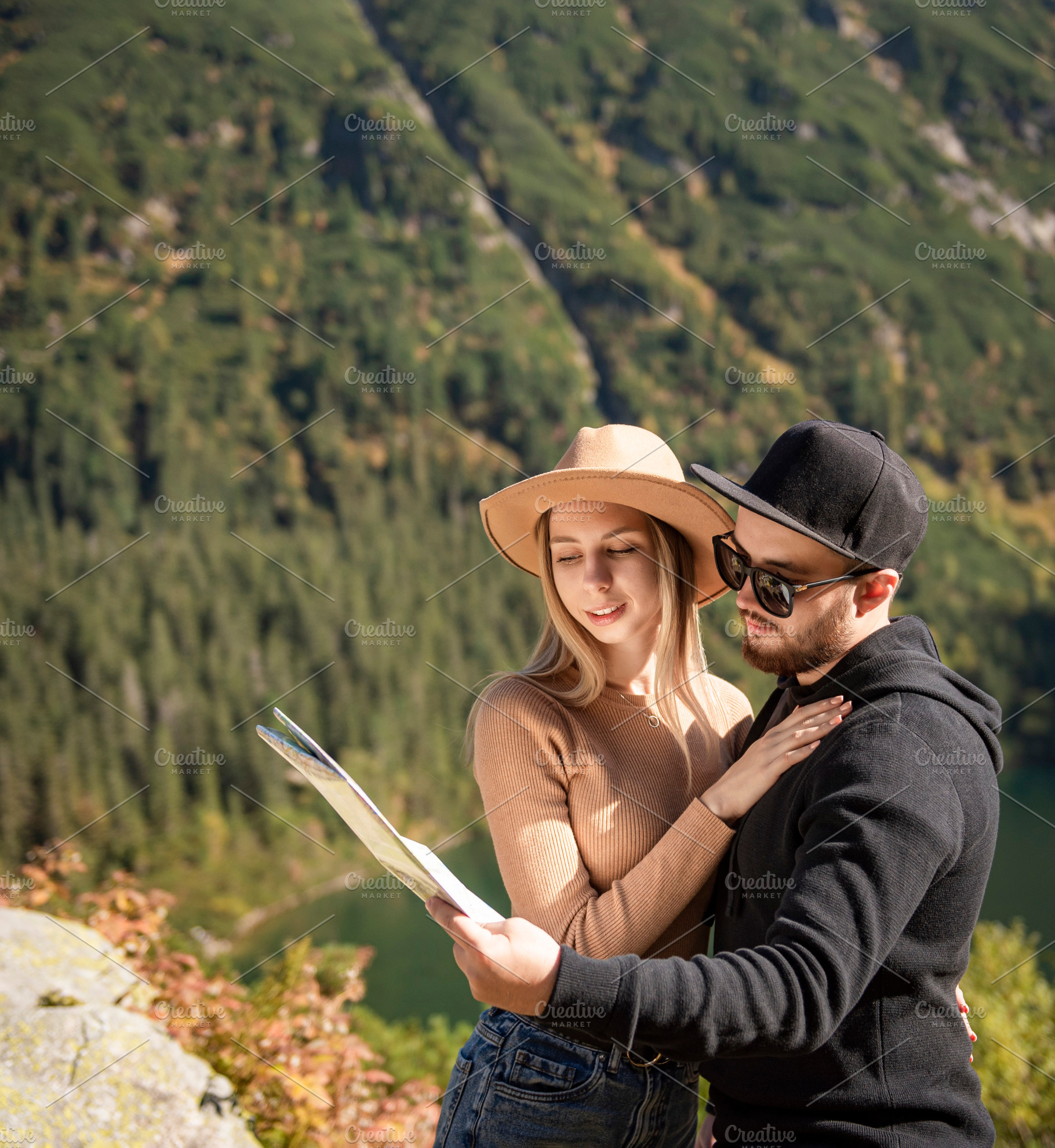 Young tourist couple, man and woman, on hiking path in mountains, a Person Photo by Olena Rudo