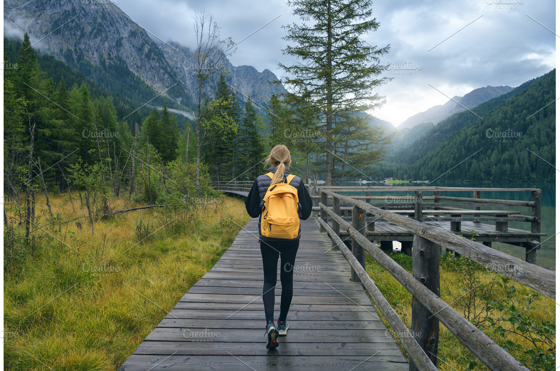 Woman with yellow backpack walking, a Person Photo by den-belitsky